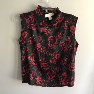 Sleeveless black top with red roses.